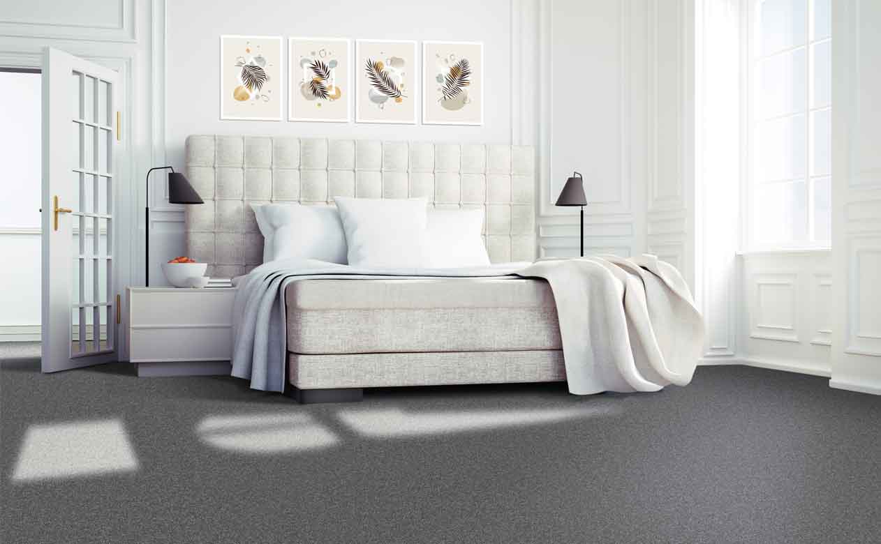 Bedroom with bed and window, grey carpeted floor