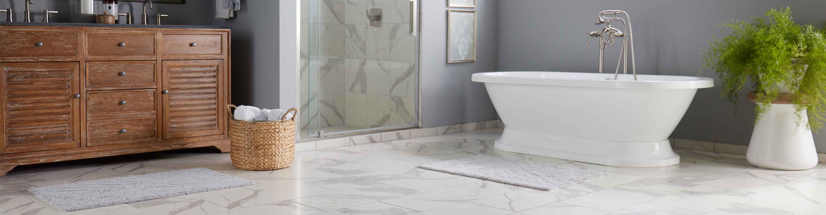 Bathroom in Denham Springs, LA with marble look tile flooring and freestanding bathtub